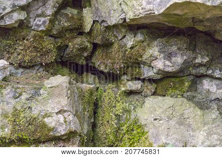 natural outdoor photography of a mossy layered rock formation