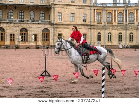 Gatchina St. Petersburg Russia - September 30 2017: Horse show of Cossacks on the parade ground of the Gatchina Palace. Young Cossack performs tricks on horseback.
