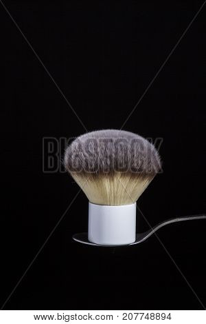 fluffy brush for powder or blush on a black background