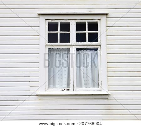 Window on a wooden white house in Iceland
