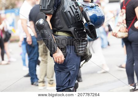 Police officer on duty at a street protest. Law enforcement. Counter-terrorism.