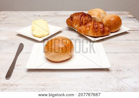 an Hard roll call it in Dutch Pistolee and croissant whit knife and butter