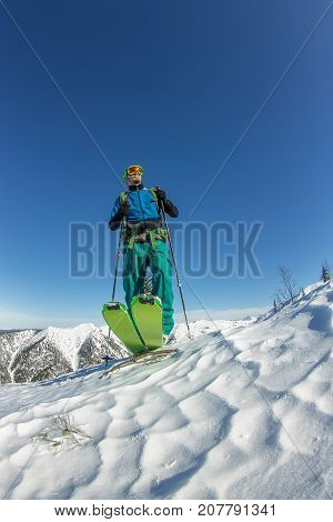Man Skier Freerider Standing At Top Of Ridge, Adventure Winter Freeride Extreme Sport