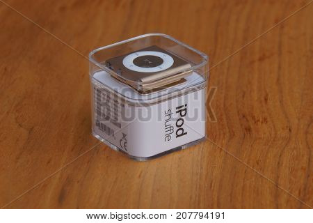 Almere, The Netherlands - October 8, 2017: Apple iPod Shuffle Gold against a wooden background.