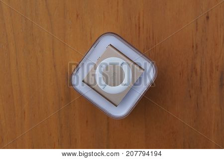 Almere, The Netherlands - October 8, 2017: Apple iPod Shuffle Gold against a wooden background.