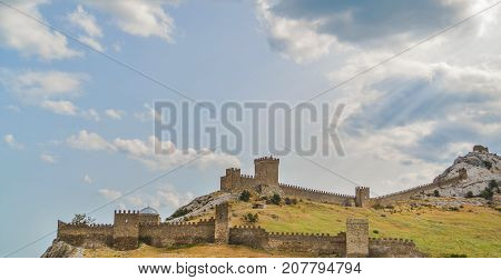 Genoese fortress in Sudak, the Crimea Peninsula, Black sea. Consular castle and the fortification wall of the upper tier. Part of the wall, Museum-reserve 