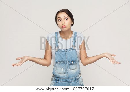Negative Human Emotions, Facial Expressions. Puzzled  Young Adult Woman With Arms Out, Shrugging Her