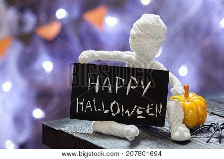 Cute funny mummy. Halloween decoration on table