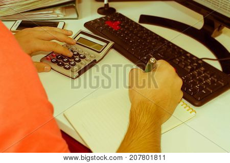 Hands of accountant Businessman with calculator and pen. Business male Analyzing Statistics Financial business Concept - Retro color