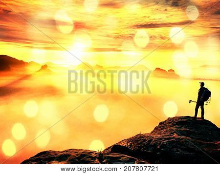 Man Silhouette With Poles In Hand. Sunny Spring Daybreak.  Hiker With Sporty Backpack Stand On Rocky