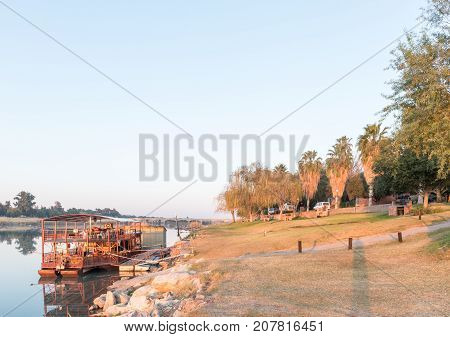 UPINGTON SOUTH AFRICA - JULY 7 2017: Sunrise at Sakkie se Arkie a river boat at a holiday resort with the same name next to the Orange River at Upington