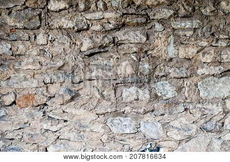 Old stone wall background with white bricks