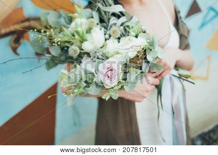 Woman holding a decorative bouquet in outdoor