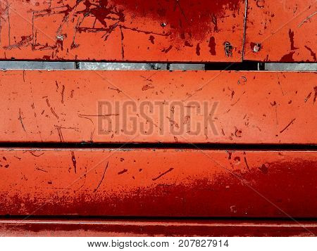 Old red wooden planks weathered from a bench