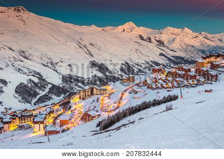 Amazing winter sunrise landscape and ski resort with typical alpine wooden houses in French Alps Les Menuires 3 Vallees France Europe