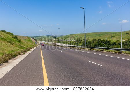 Scenic road vehicle entry ramp onto highway travel route landscape.