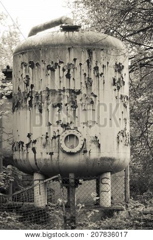 Old silo for public pool chlorine on trees plane.