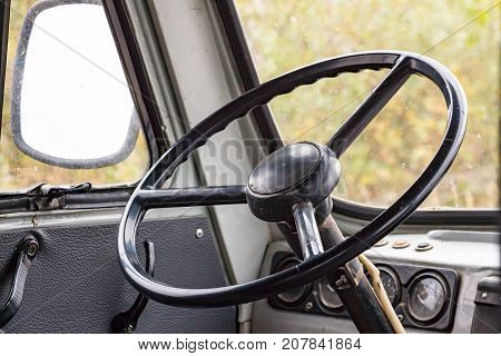 The steering wheel in the cockpit of an old car. Retro style