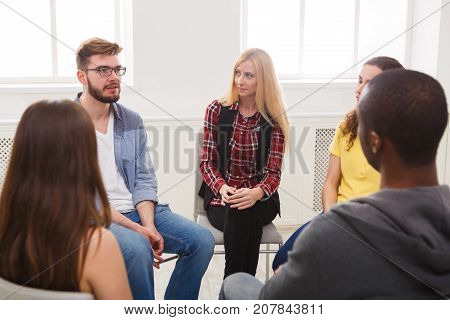 Meeting of support group. Young woman therapist listening to other people. Mental health, psychotherapy concept