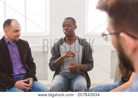 Meeting of support group. African-american man talking about his life, telling his problems and issues. Mental health, psychotherapy concept