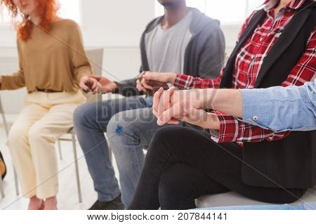 Trust circle. Company of people sitting together with united hands. Meeting of support group
