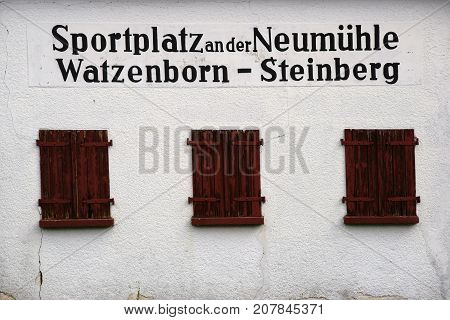 WATZENBORN-STEINBERG, GERMANY - SEPTEMBER 30: The facade of an old cottage at the entrance of the sports field at the New mill on September 30, 2017 in Watzenborn-Steinberg.