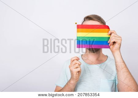 Young man hold a rainbow flag, gey boy.