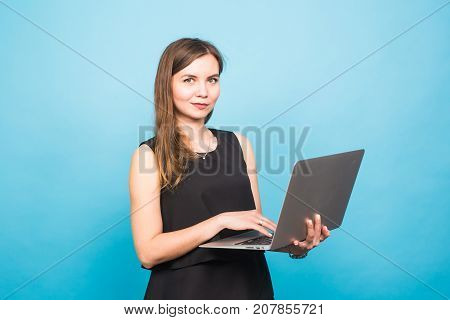 Smart beautiful young woman using laptop pc computer isolated on blue background.