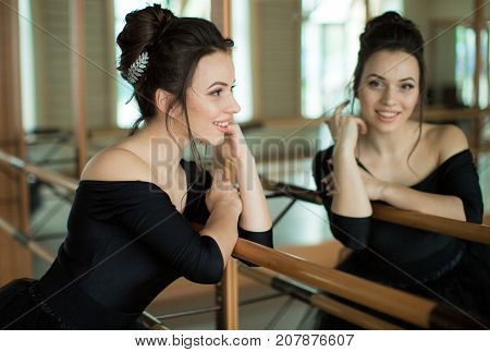 young ballerina is relaxing in class room