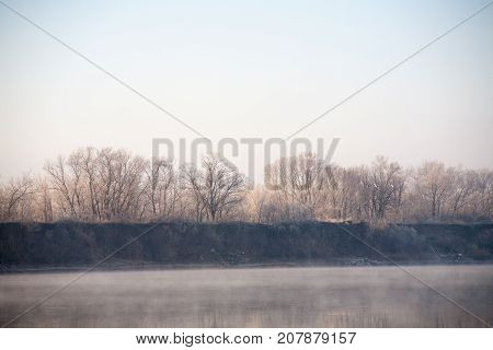 Morning on the river early morning reeds mist fog and water surface on the river