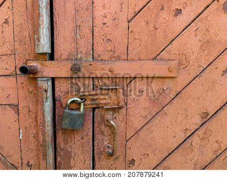 old brown door with a lock on the photo.