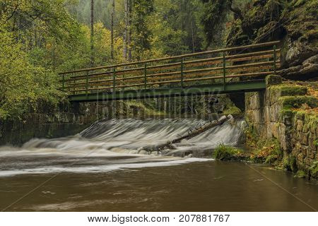 Bridge over Chribska Kamenice river in national park Ceske Svycarsko in autumn morning