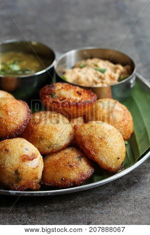 Kuzhi Paniyaram served with coconut chutney and sambar- South Indian breakfast with black lentils and rice