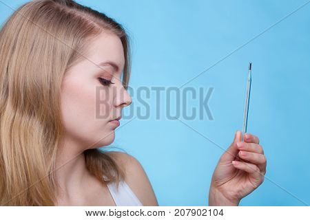 Disease sickness allergy malady problem concept. Young woman feeling bad being sick and looking at thermometer