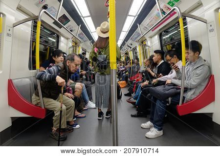People Sitting On Subway Train In Hong Kong