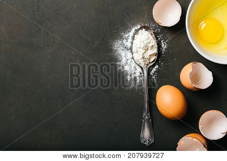 Baking or cookingbackground with raw eggs and flour