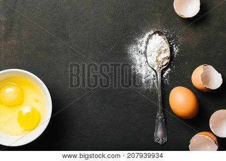 Baking or cookingbackground with raw eggs and flour