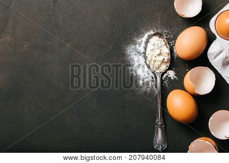 Baking or cookingbackground with raw eggs and flour