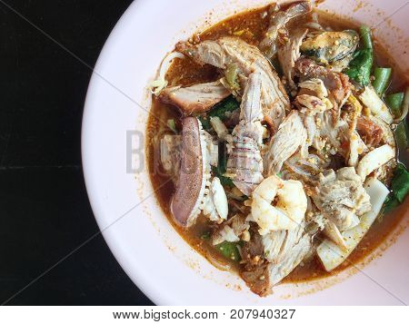 Noodles Seefood Tom Yum With Squid And Mantis Shrimp, Squid, Prawn In A Bowl On Wooden Table, Still