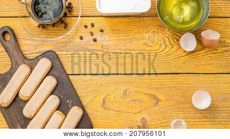 Photo on top of table with savoyardi cookies, coffee, cream cheese. Place for text