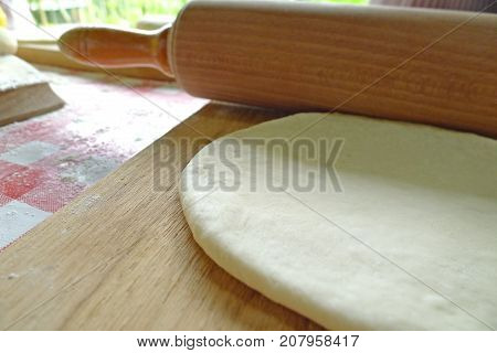 rolling pin and dough to make resh bread