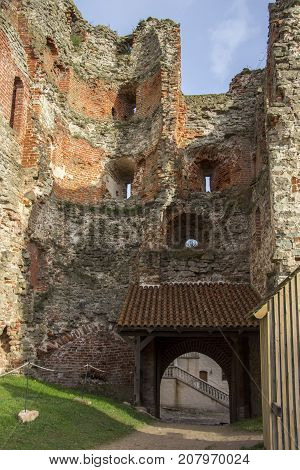 The ruins of the Livonia Order Castle was built in the middle of the 15th century. Bauska Latvia in autumn. Latvian flag on the top of the tower
