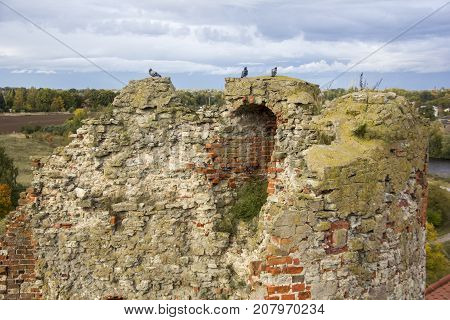 The ruins of the Livonia Order Castle was built in the middle of the 15th century. Bauska Latvia in autumn. Latvian flag on the top of the tower