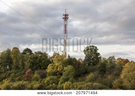 Antenna and cell phone towers on a mountaintop on a clear dayin autumn.