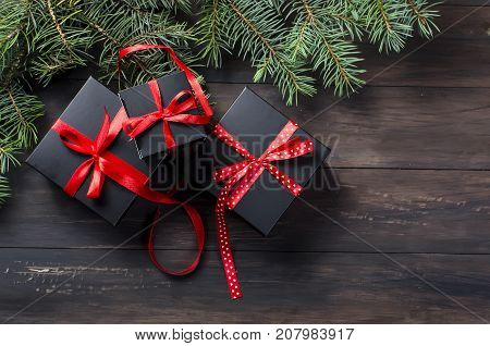 Black Christmas  Gift  Box With Red Ribbon And Fir Branches