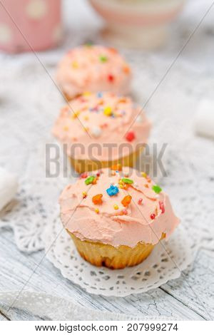 Traditional Easter cupcake with decorations and cupcakes on wooden table