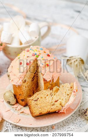 Traditional Easter cake with decorations and cupcakes on wooden table