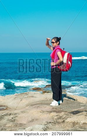 A girl explores the coastline of Bondi Beach in SydneyAustralia.