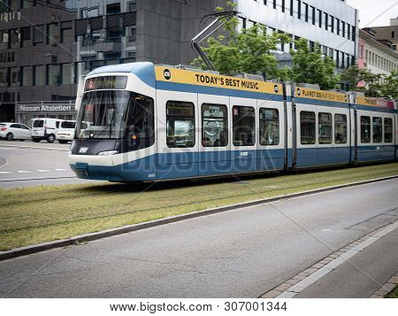 A Modern Electric Tram, As A Part Of Zurich Transport Network Or Zvv, Running Along Tracks Around Zu