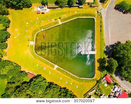 Aerial view to swimming pool and water reservoir in beautiful landscape close Kdyne town. Popular recreational area in Western Bohemia. Czech Republic, Europe.